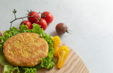 Fresh vegan chickpea burger (cutlets), tomatoes and lettuce. Home made with vegetables and chickpeas.The concept of healthy and vegetarian food. Place for text. Plant based food concept.