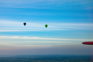 Balloon against the blue sky. Sky landscape from the plane.
