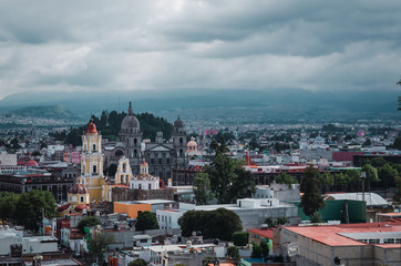 Fototapeta na wymiar Urban landscape of the City of Toluca, Mexico, where you can see several of the emblematic sites such as the Cathedral, the Cerro del Calvario, a traditional Mexican multicolored panorama.