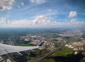 Airplane travel flying above the scenery landscape wing look through the plane window