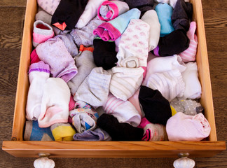 Drawer filled to the top with socks; Open drawer showing abundance of socks