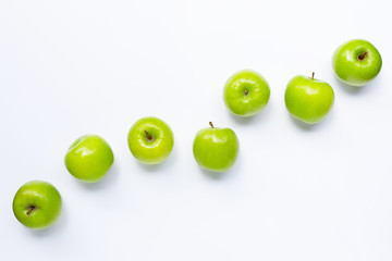 Fresh green apples on  white plate on white background.