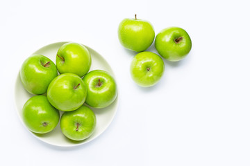 Fresh green apples on  white plate on white background.