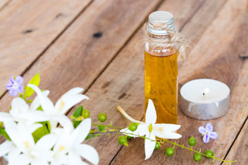 herbal essential oils aromatherapy extract flowers cock tree local flora of asia and candlelight of lifestyle relaxation decoration on background wooden