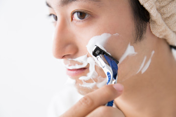 髭剃りをする男性