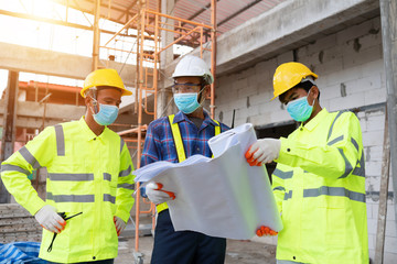 Construction the engineering and worker reading blueprint in  the construction site