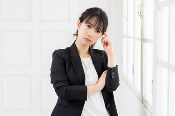 考えるジェスチャーをする若い女性