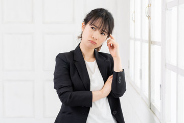 考えるジェスチャーをする若い女性