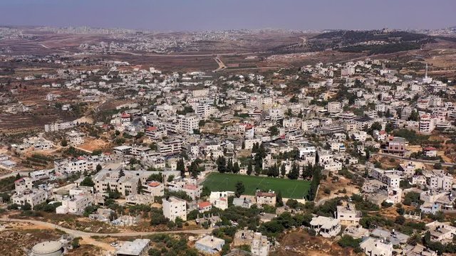 Aerial View over Palestinian Town Biddu with soccer field, Near Jerusalem 
Drone, August,2020,Israel
