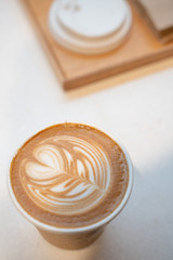 A cup of coffee latte with milk cover on it.