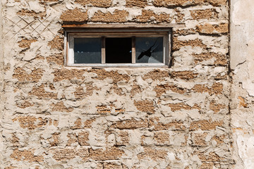 Fototapeta na wymiar Broken glass in a building window. Housing problems