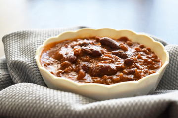 Chilli con carne on a white bowl.  Mexican food. Selective focus.