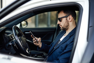 An entrepreneur inside his car driving to make some deals