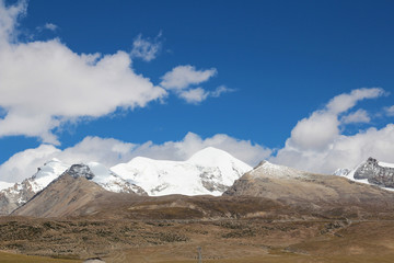 View of ice mountains with the dramatic sky in Tibet, China