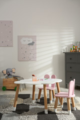 Little table and chairs with bunny ears in children's room. Interior design