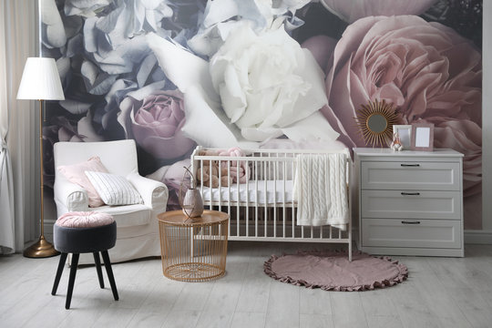 Baby Room Interior With Stylish Crib And Floral Wallpaper