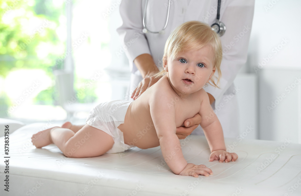 Poster Pediatrician examining baby in hospital. Health care