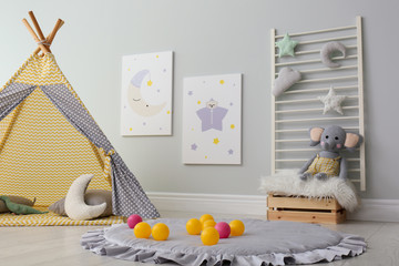 Stylish child's room interior with adorable paintings and play tent
