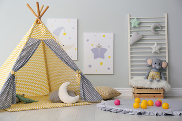 Stylish child's room interior with adorable paintings and play tent © New Africa