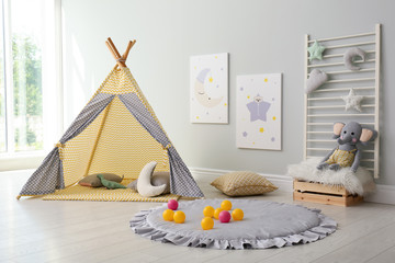Stylish child's room interior with adorable paintings and play tent © New Africa