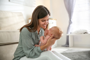 Mother with her newborn baby at home