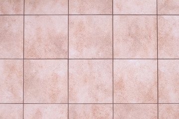 Ceramic tile floor texture, stone wall background. Square pattern, smooth brown marble in the kitchen, bathroom. Abstract grunge frame, interior element.