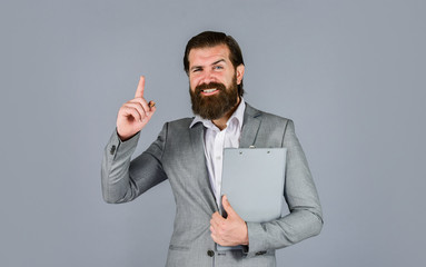 get inspired. Ready for sale. Pleasant cheerful handsome realtor holding folder. bearded man work in office. Portrait of successful businessman dressed in formal clothes. serious boss with document