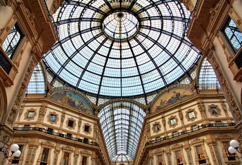 Fototapeta premium Panorama inside the Galleria Vittorio Emanuele II in Milan. This gallery is famous shopping mall and Milan landmark. Beautiful interior of the old Milan store in summer.