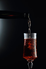 Aged golden fortified wine from the antique bottle being poured into a crystal glass.