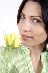 Woman with yellow rose smiling at the camera