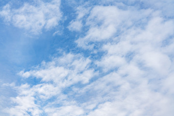 .White cumulus clouds against the background against blue on a blue background.