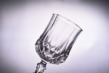 Close up of empty clean transparent Glass goblet against white background.