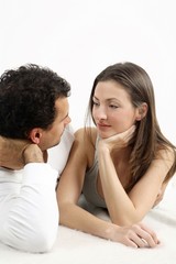 Man and woman lying forward, looking at each other