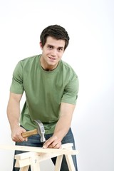 Man hammering nail into wood