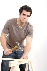 Man hammering nail into wood