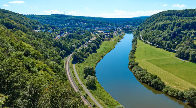 Aerial view of the river Weser near Beverungen, Germany, with a bicycle path and railroad tracks on the bank