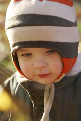 Preschooler in winter clothes in the park