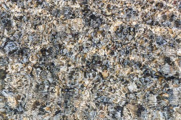 sea pebbles in the water, ripples on the water