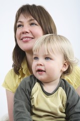 Mother and son smiling while looking away