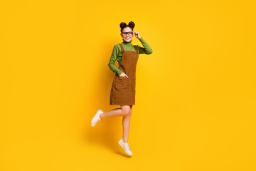 Fototapeta na wymiar Full length photo of cheerful dreamy girl jump touch specs wear green sweater skirt overall gumshoes isolated over bright shine color background