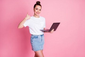 Photo of positive girl work remote use laptop recommend show thumb up sign wear white t-shirt denim jeans isolated over pastel color background