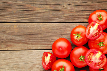 Ripe red tomatoes on a grey wooden background