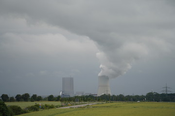 Fototapeta na wymiar Coal power plant polluting the planet, thick chimney smoking towards the sky.