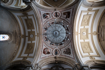 Church ceiling with a big lamp and paintings