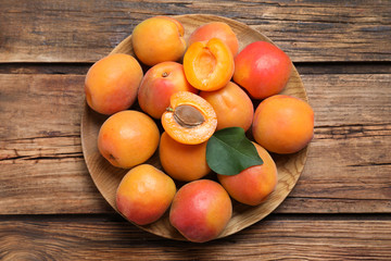 Delicious fresh ripe apricots on wooden table, top view