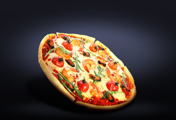 Hot tasty seafood pizza on dark background. Image for menu or poster