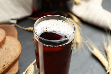 Glass of delicious kvass on table, closeup