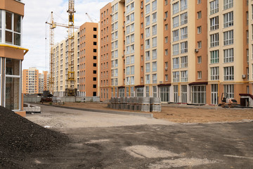 View on construction place with dirt land and unfinished houses