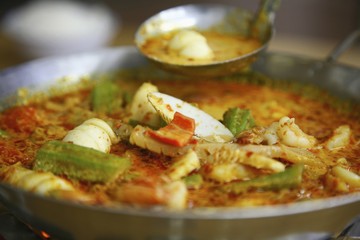 Seafood curry in wok