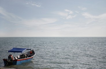 Naklejka premium Boat harboured at sea